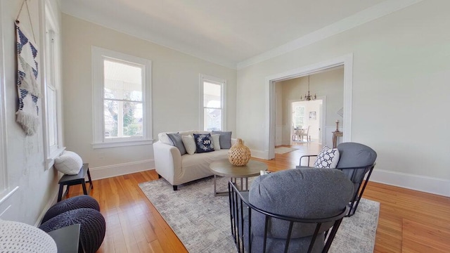 living room with an inviting chandelier and light hardwood / wood-style flooring