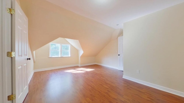 bonus room with vaulted ceiling and hardwood / wood-style floors