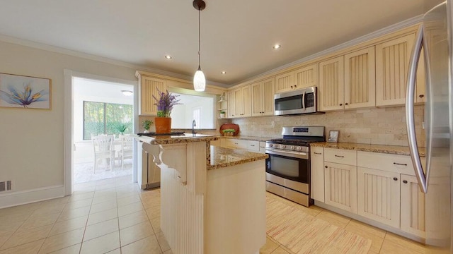 kitchen featuring a breakfast bar, a center island, appliances with stainless steel finishes, pendant lighting, and light stone countertops