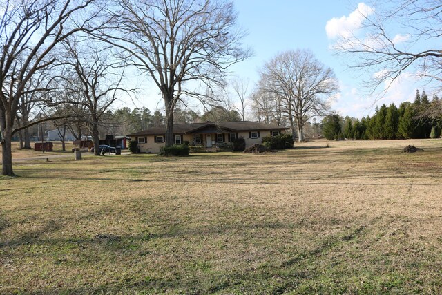 view of pool with a diving board and a lawn