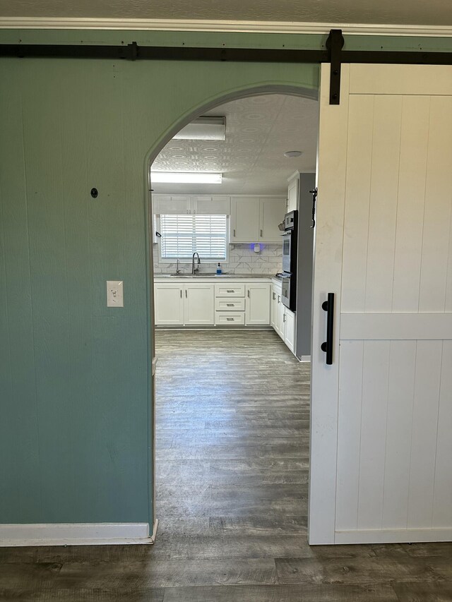 dining space featuring hardwood / wood-style floors, ornamental molding, and a textured ceiling