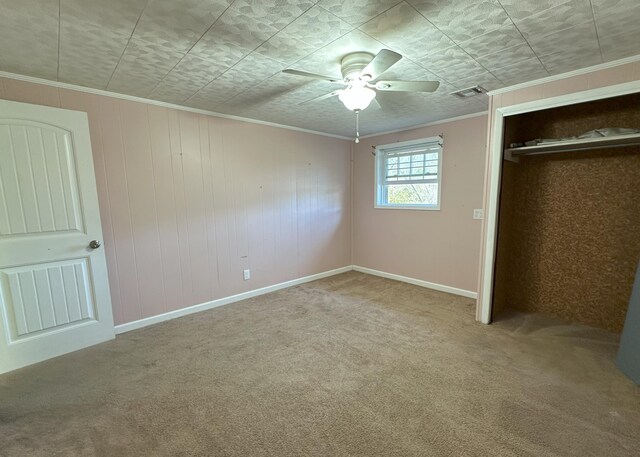 bedroom featuring ceiling fan, wooden walls, and carpet floors