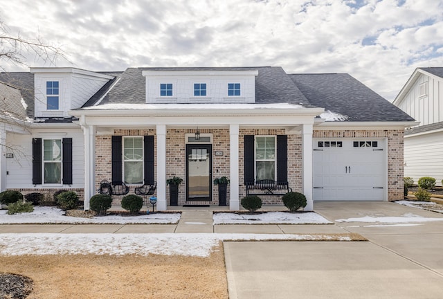 view of front of house featuring a porch and a garage