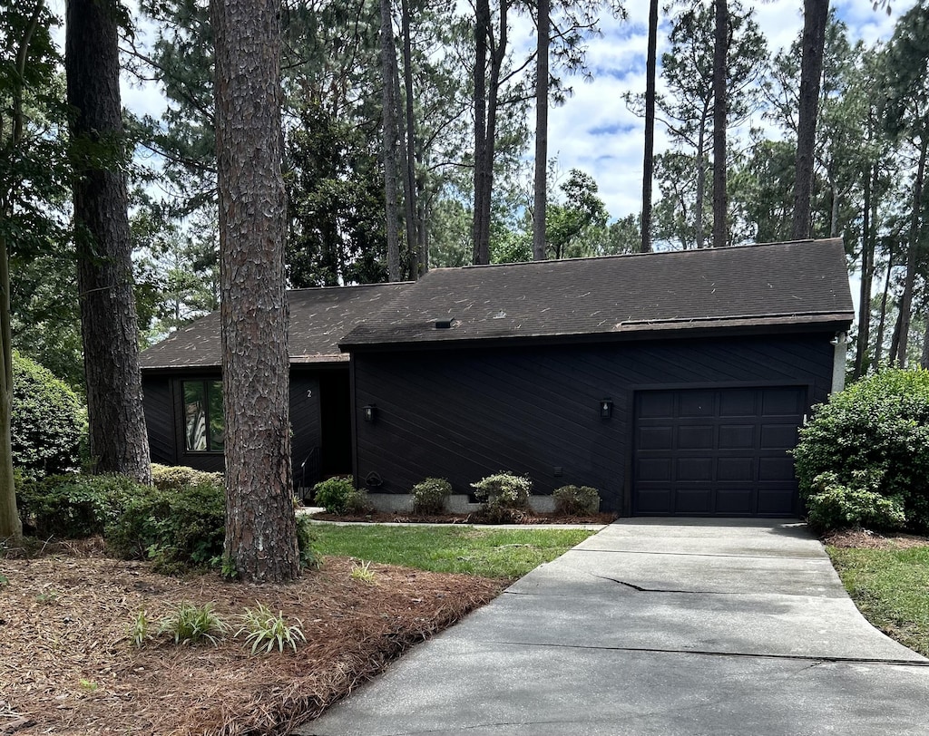 2 W Birkdale Ct, Aiken, SC 29803 - mid-century home featuring concrete driveway, a garage, and roof with shingles
