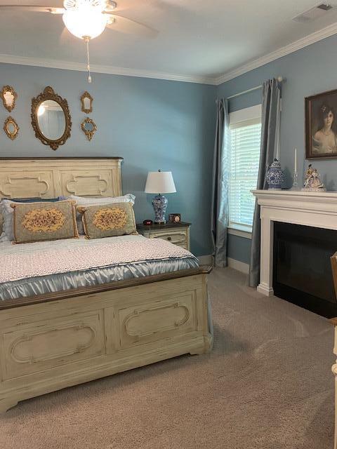 256 Candlewick Loop, Mccormick, SC 29835 - carpeted bedroom with crown molding, a fireplace, and a ceiling fan