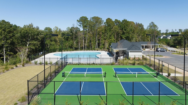 view of sport court with a fenced in pool