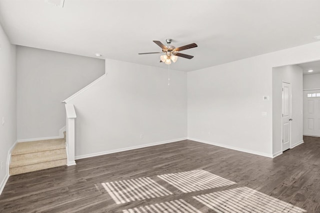 unfurnished living room with dark hardwood / wood-style floors and ceiling fan