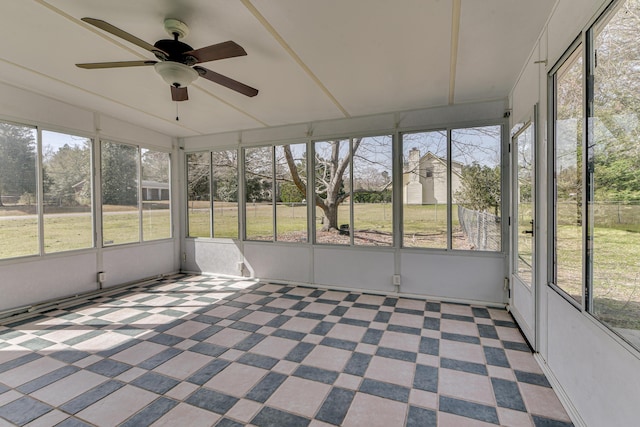 unfurnished sunroom with ceiling fan and lofted ceiling