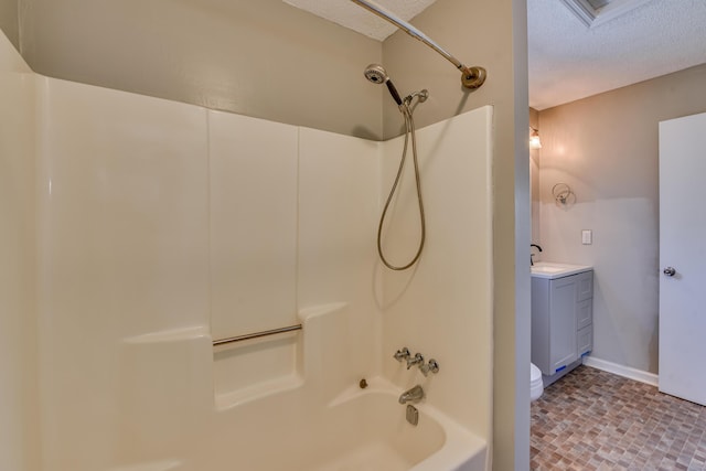 full bathroom with shower / bath combination, toilet, a textured ceiling, and vanity