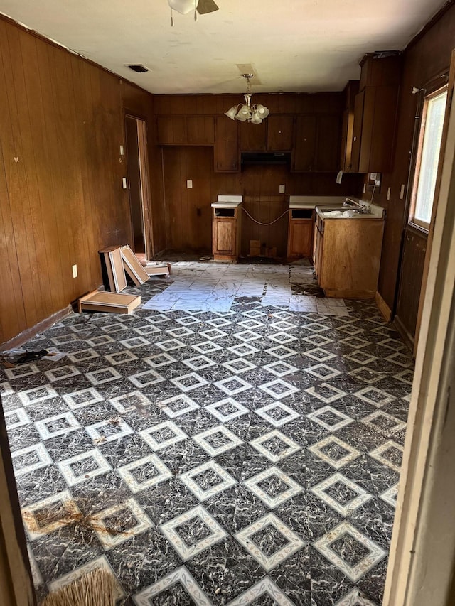 3415 Cauthen Dr, Augusta, GA 30906 - kitchen featuring wood walls, a chandelier, and baseboards