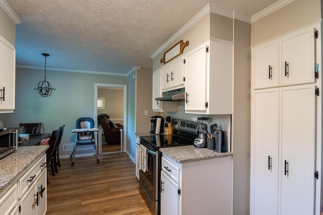 4387 Quail Creek Rd, Martinez, GA 30907 - kitchen featuring appliances with stainless steel finishes, under cabinet range hood, wood finished floors, white cabinetry, and decorative backsplash