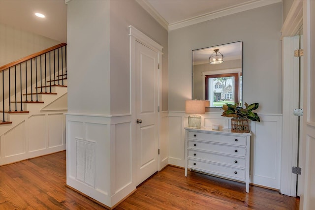 corridor featuring hardwood / wood-style flooring and ornamental molding