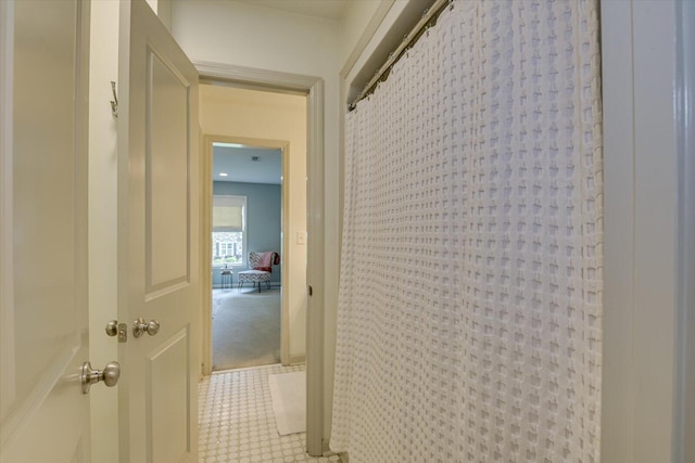 corridor with light colored carpet