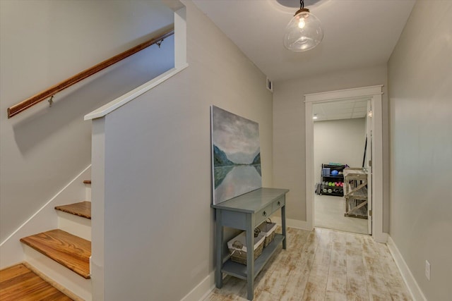 hallway with hardwood / wood-style flooring