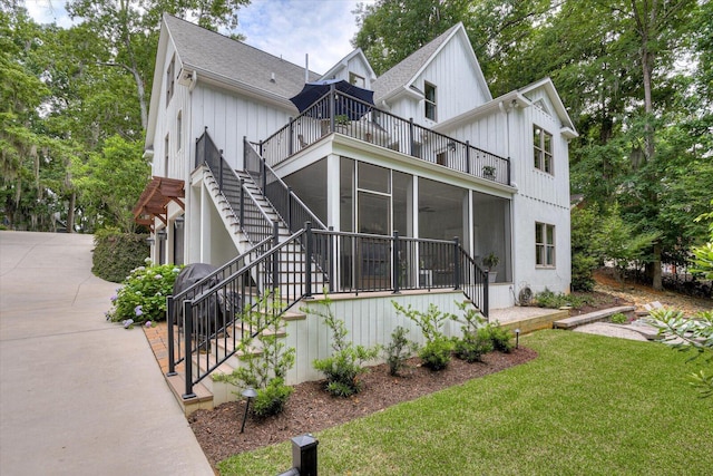 view of front of property with a front yard and a sunroom