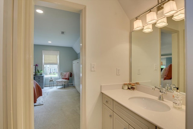 bathroom featuring vanity and vaulted ceiling