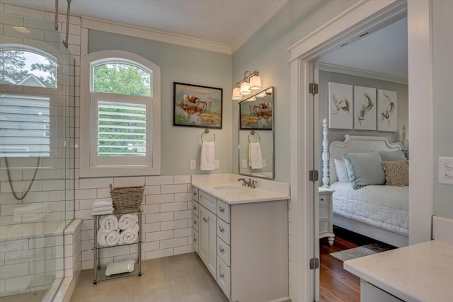 bathroom featuring a shower, hardwood / wood-style flooring, vanity, and ornamental molding