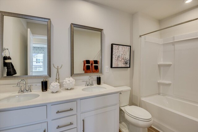 full bathroom with shower / washtub combination, vanity, and toilet