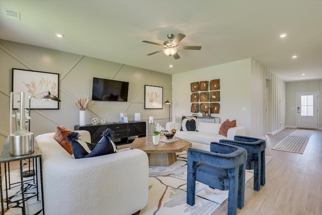 living room with light wood-type flooring and ceiling fan