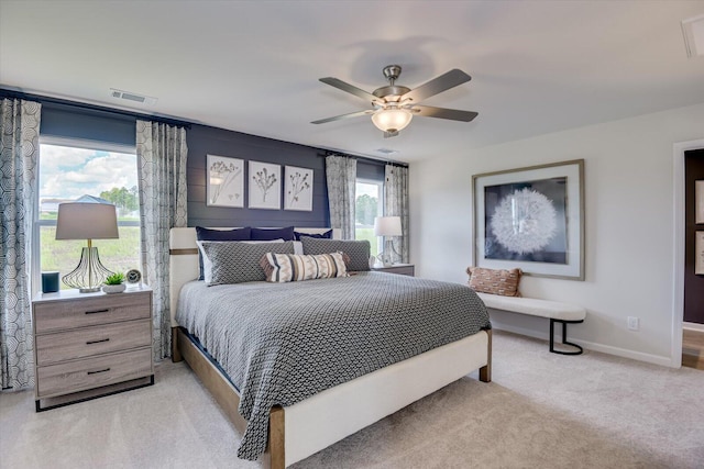 bedroom with ceiling fan and light carpet