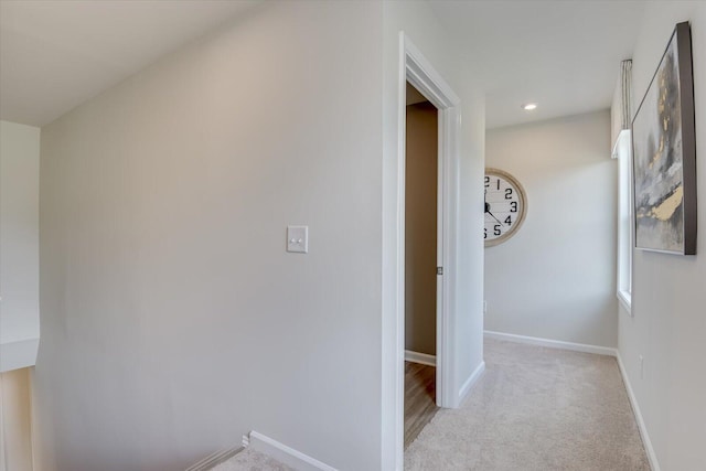 hall featuring light colored carpet