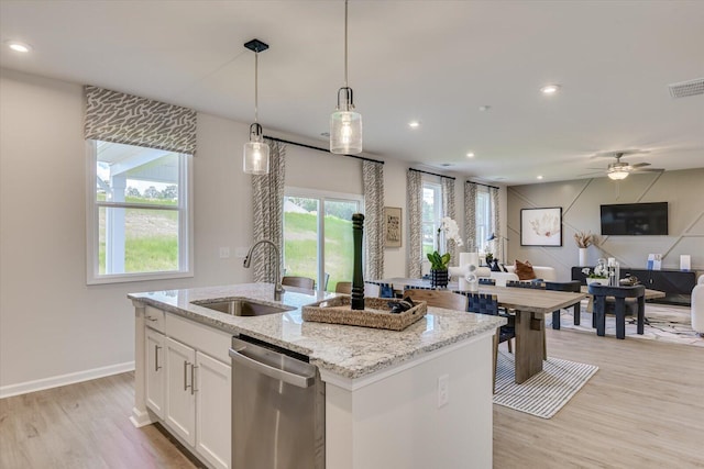 kitchen with sink, stainless steel dishwasher, an island with sink, decorative light fixtures, and white cabinets