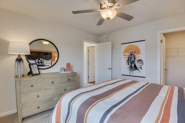 carpeted bedroom with a closet, a spacious closet, and ceiling fan