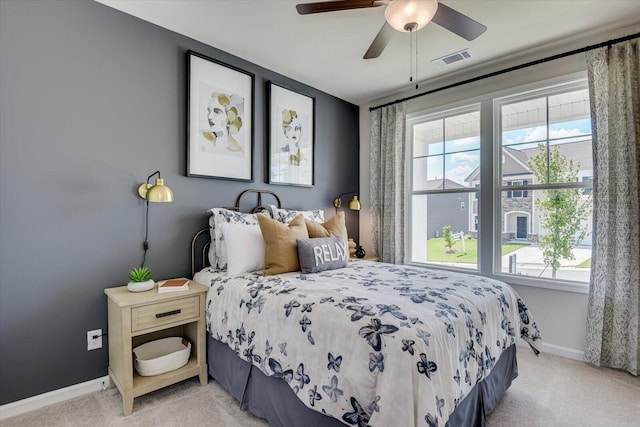 bedroom with light carpet and ceiling fan