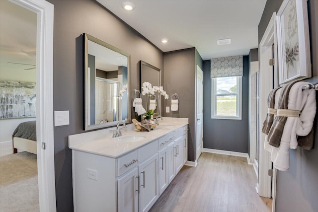 bathroom featuring hardwood / wood-style floors, vanity, ceiling fan, and an enclosed shower