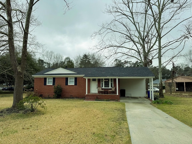 view of front of property featuring driveway, brick siding, crawl space, and a front lawn