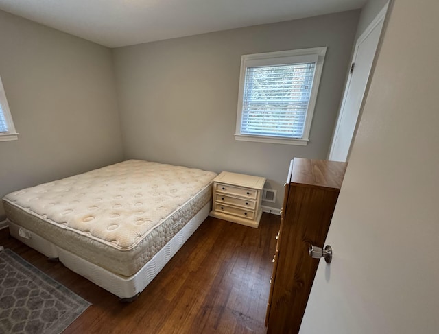 bedroom featuring dark wood-type flooring and visible vents