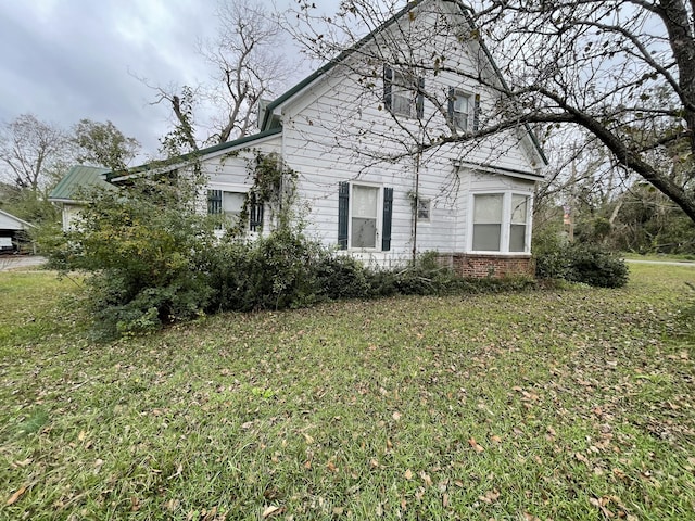 view of property exterior with a lawn