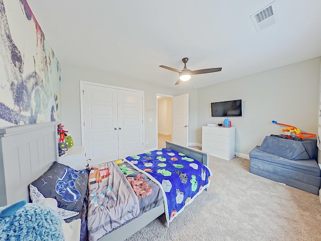 bedroom with carpet, a closet, and ceiling fan