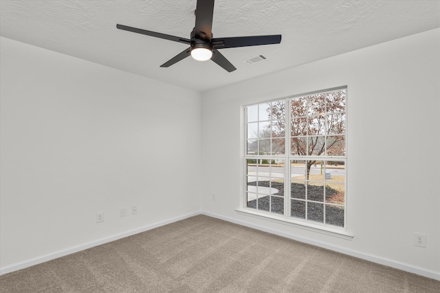 unfurnished room featuring ceiling fan, a textured ceiling, and carpet flooring