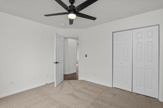 unfurnished bedroom featuring ceiling fan, carpet floors, and a closet