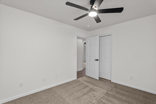 unfurnished bedroom with carpet, ceiling fan, and a closet