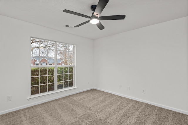 carpeted empty room featuring ceiling fan