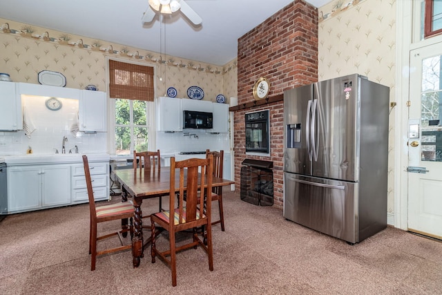 dining room with light carpet, ceiling fan, and sink