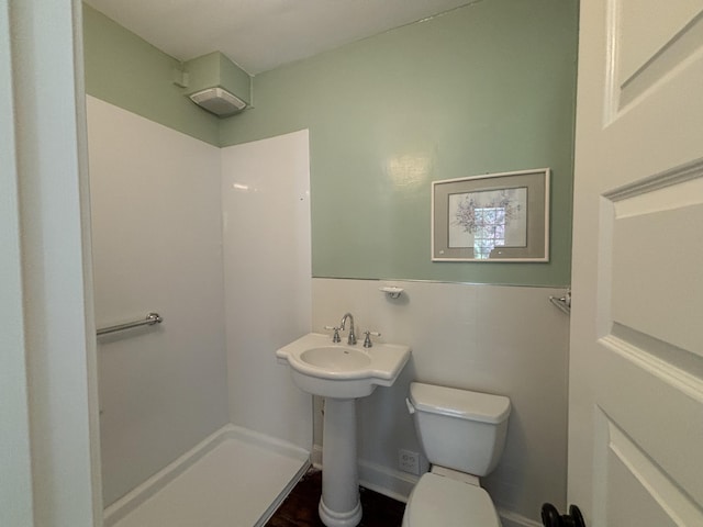 bathroom with a shower and toilet