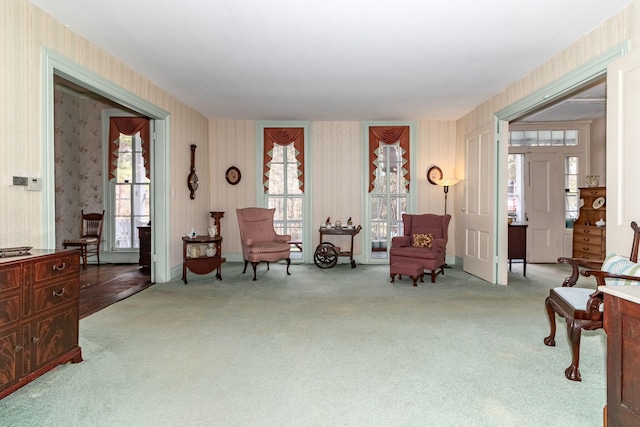 living area with light colored carpet and a healthy amount of sunlight