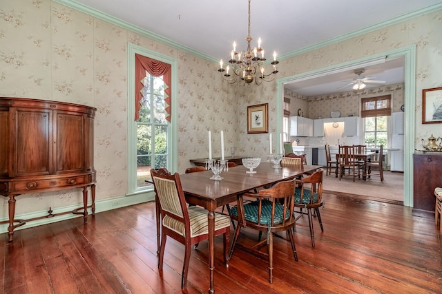 dining room with hardwood / wood-style floors, ceiling fan with notable chandelier, and crown molding