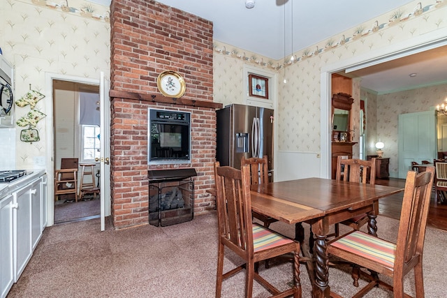 carpeted dining room featuring a fireplace