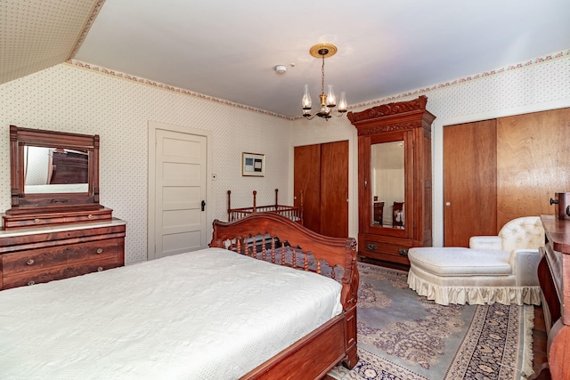 bedroom with an inviting chandelier and lofted ceiling