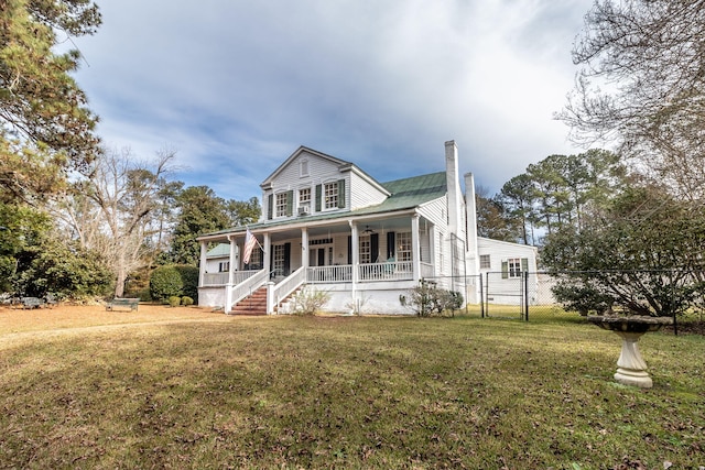 view of front of home featuring covered porch and a front lawn