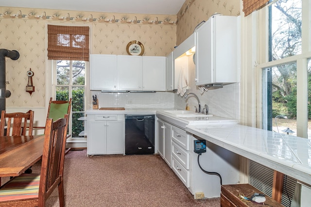 kitchen featuring backsplash, white cabinetry, dishwasher, and sink