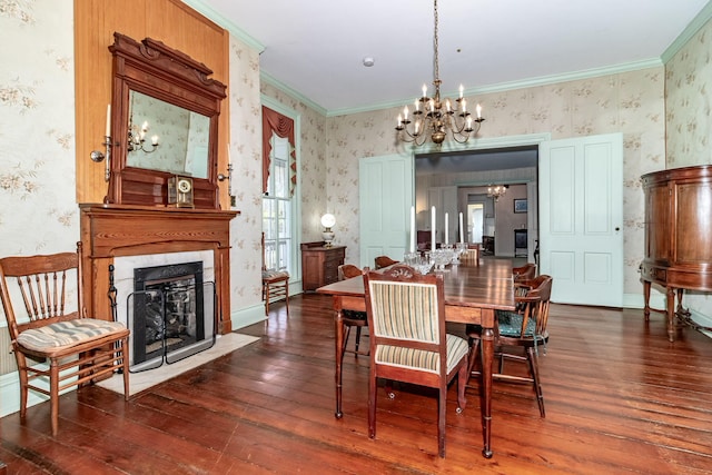 dining space featuring ornamental molding, a notable chandelier, a premium fireplace, dark hardwood / wood-style floors, and plenty of natural light