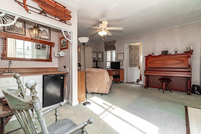 living room featuring light carpet, ceiling fan, and sink