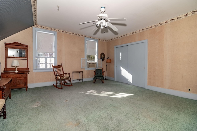 living area featuring carpet flooring, ceiling fan, and cooling unit