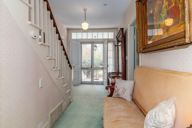 foyer with carpet and french doors