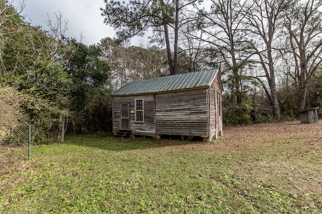 view of outbuilding featuring a lawn